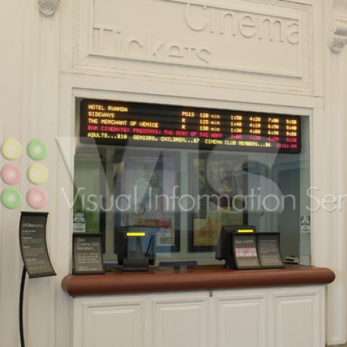 Cinema ticket counter with digital display board.