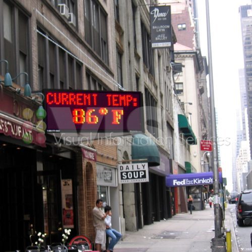 Street scene with temperature sign 86°F.