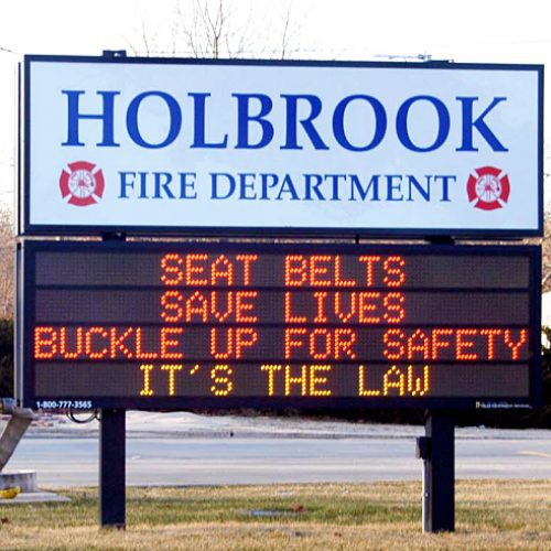 Fire department sign urging seat belt use.