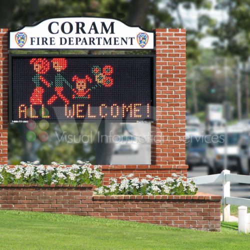 Coram Fire Department welcome sign with flowers.