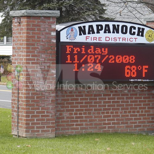 Brick sign displaying date and temperature.
