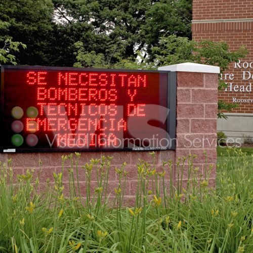 Fire department sign seeking emergency personnel.
