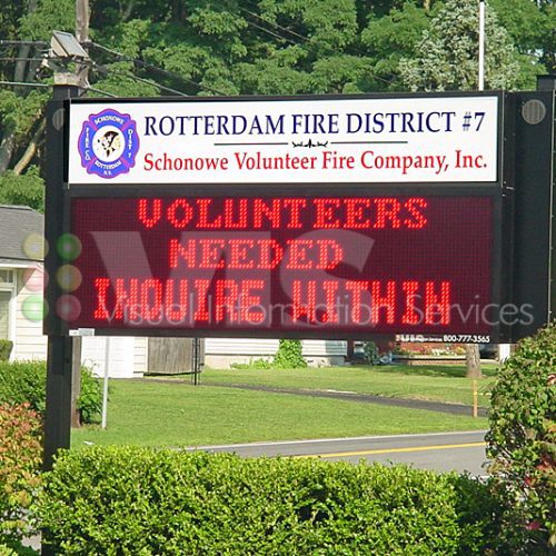 Fire station sign seeking volunteers.