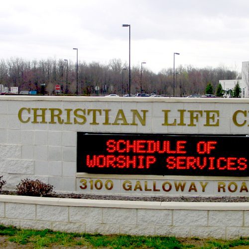Christian Life Center entrance sign with schedule.