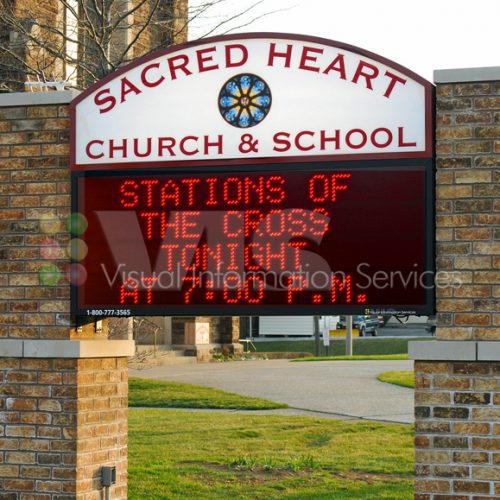Sacred Heart Church sign with event details.