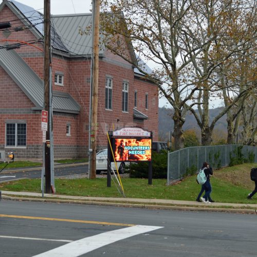Brick building with electronic volunteer sign outside.