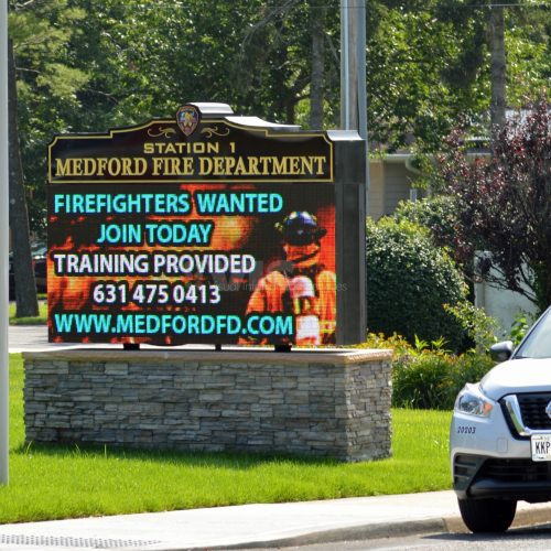 Medford Fire Department recruiting sign with car.