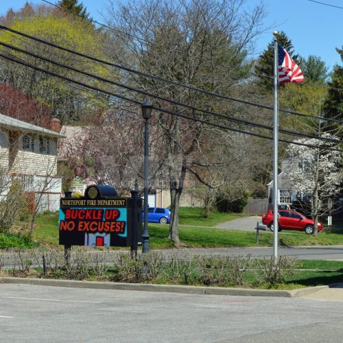 Fire department sign urging seatbelt use.