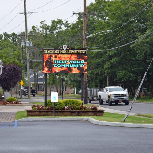 Fire department sign urging community support.