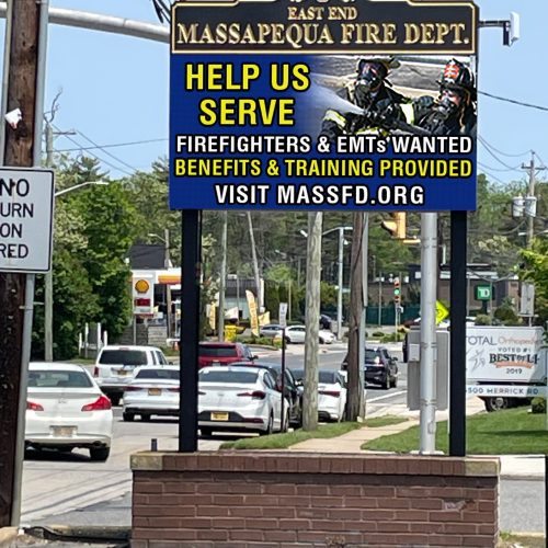 Fire department recruitment sign on a street.