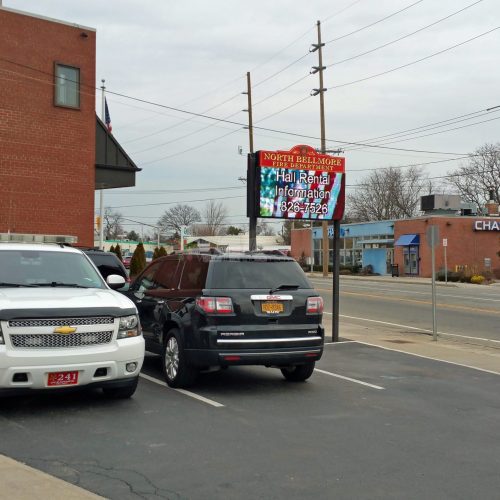 Two parked SUVs near brick building.