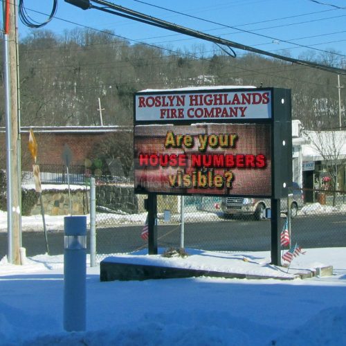 Fire station sign asking about house numbers.
