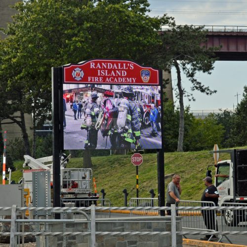Randall's Island Fire Academy sign with firefighters.
