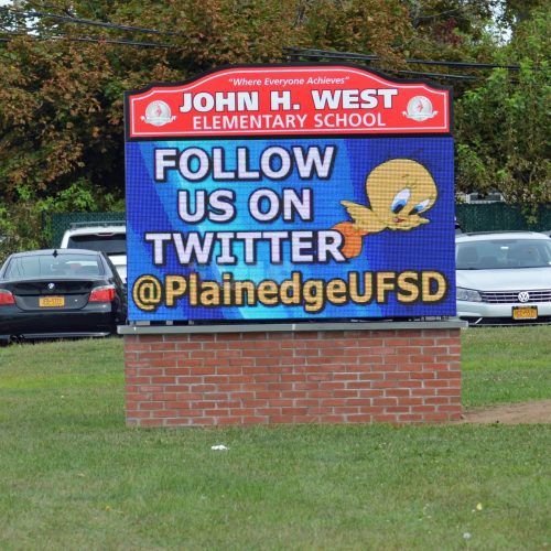 School sign promoting Twitter account.