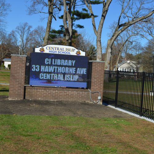 Central Islip High School sign and trees.