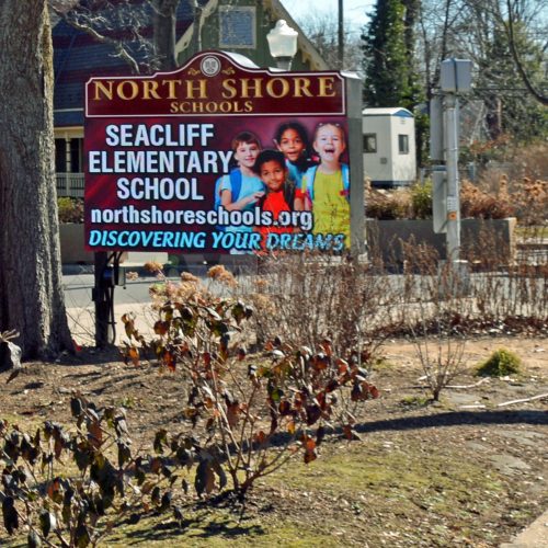 North Shore Schools sign near entrance.