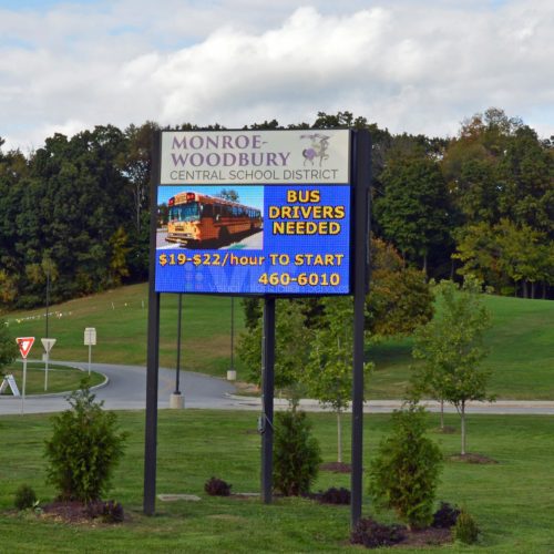 School district sign, bus drivers needed advertisement.