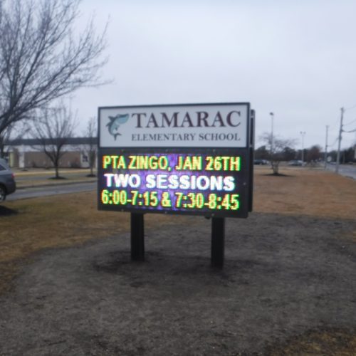 Tamarac Elementary School sign with event details.